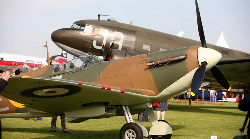 The iconic MK1 Spitfire in front of the DC3 Dakota in the Freddie March Spirit of Aviation concours