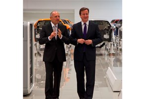 Ron Dennis (left) tells British prime minister David Cameron not to touch anything
